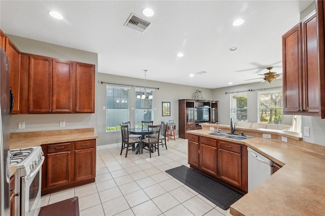 kitchen featuring ceiling fan, decorative light fixtures, sink, white appliances, and light tile patterned floors