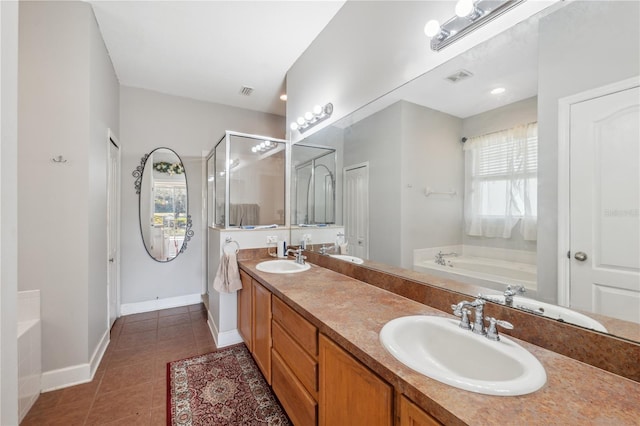 bathroom with tile patterned flooring, plus walk in shower, vanity, and a healthy amount of sunlight