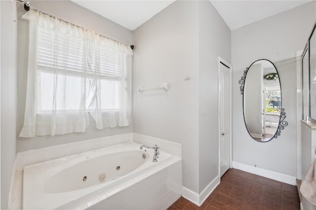 bathroom with tiled bath and tile patterned flooring