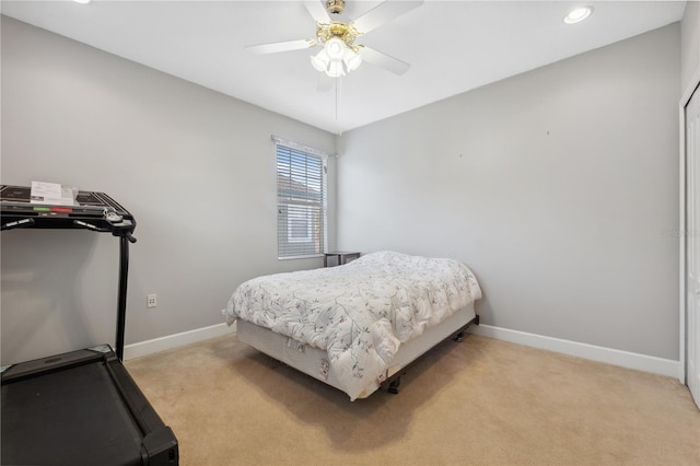 bedroom featuring light carpet and ceiling fan