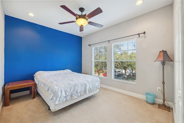 bedroom with ceiling fan and light carpet