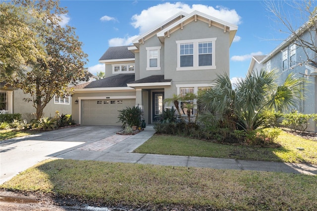 view of front of property with a front yard and a garage