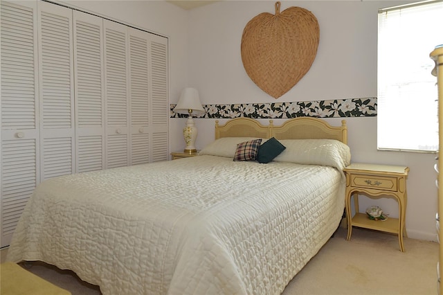 carpeted bedroom with multiple windows and a closet