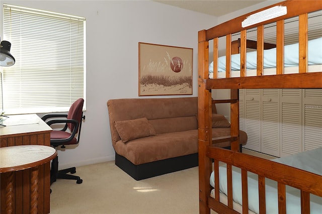 bedroom featuring light carpet