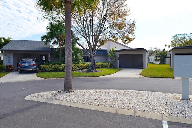 ranch-style home with a garage and a front yard