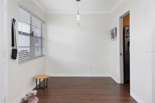 unfurnished room featuring dark wood-type flooring and crown molding