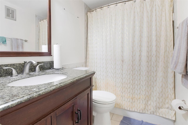 bathroom featuring vanity, toilet, and tile patterned flooring