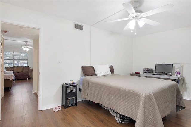 bedroom with dark wood-type flooring and ceiling fan