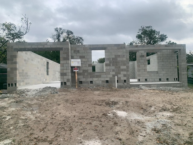 view of front of home featuring concrete block siding