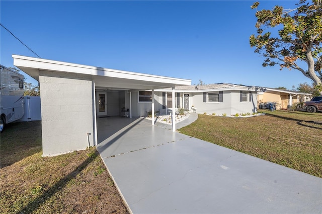 single story home featuring a carport and a front lawn