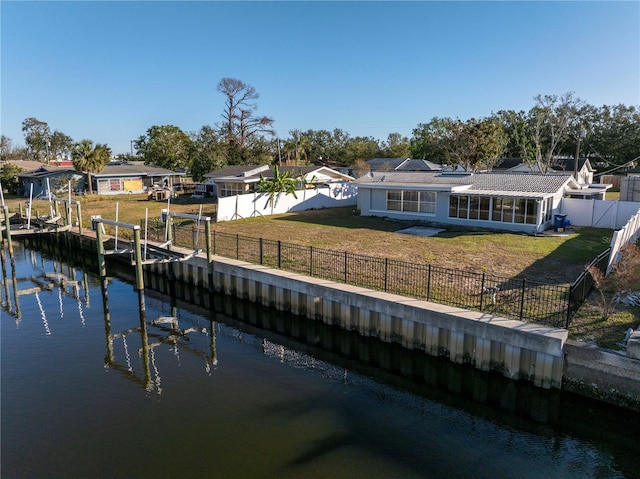 rear view of property with a yard and a water view