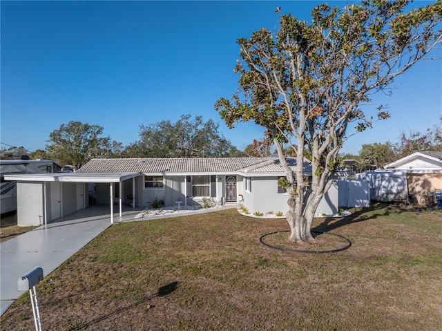 ranch-style home featuring a front yard and a carport