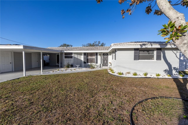 ranch-style home with a front yard and a carport