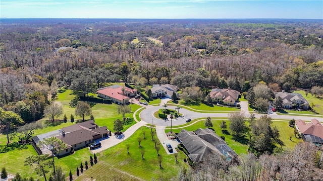 drone / aerial view with a residential view and a wooded view