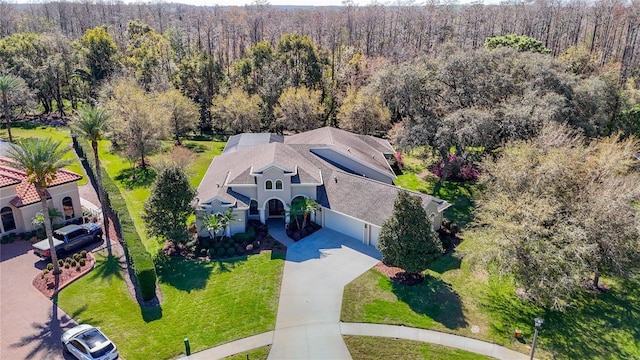 drone / aerial view featuring a view of trees