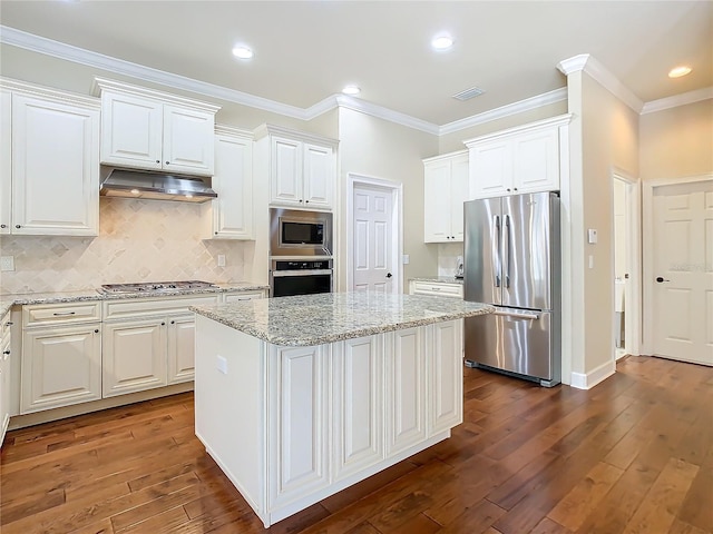 kitchen with dark wood-style floors, appliances with stainless steel finishes, a kitchen island, and under cabinet range hood