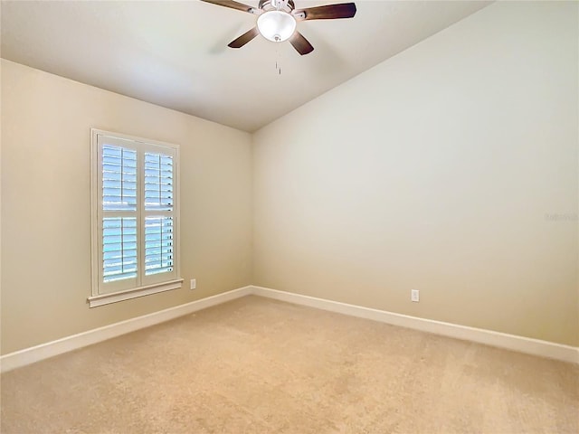 unfurnished room with light carpet, a ceiling fan, and baseboards