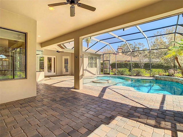 outdoor pool with a patio area, ceiling fan, and glass enclosure