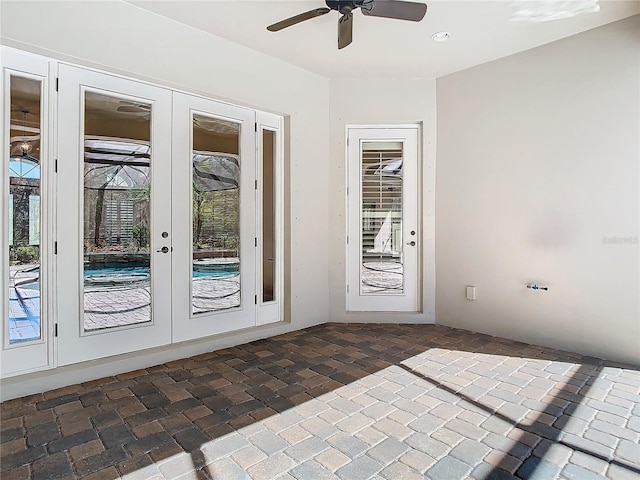 doorway with a ceiling fan and french doors