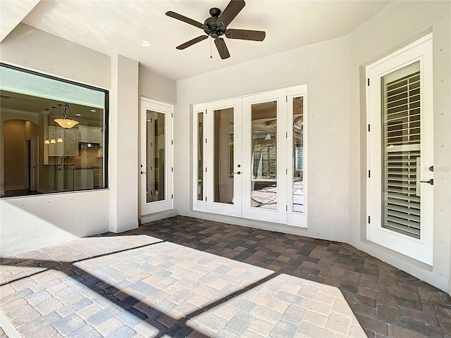 view of patio / terrace featuring ceiling fan and french doors