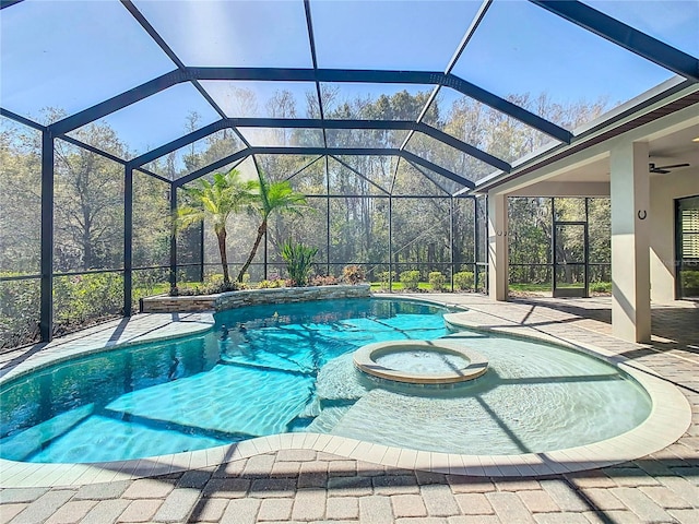 view of swimming pool with a patio area, a lanai, and a pool with connected hot tub