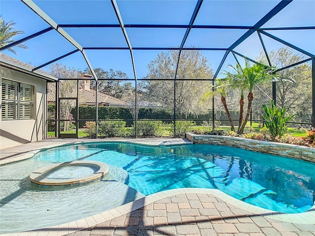 view of pool with a lanai and a pool with connected hot tub