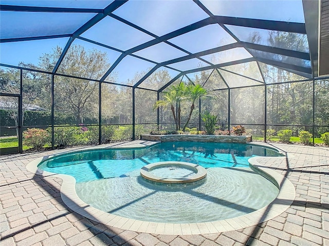 view of pool featuring a lanai, a patio area, and a pool with connected hot tub