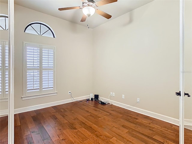 empty room featuring wood-type flooring, ceiling fan, and baseboards