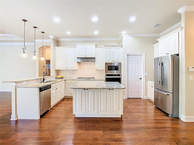 kitchen featuring visible vents, appliances with stainless steel finishes, a sink, a peninsula, and under cabinet range hood