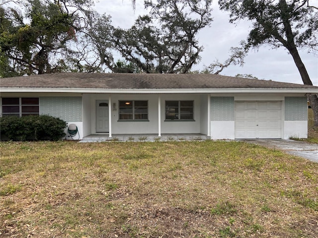 ranch-style house featuring a front lawn and a garage