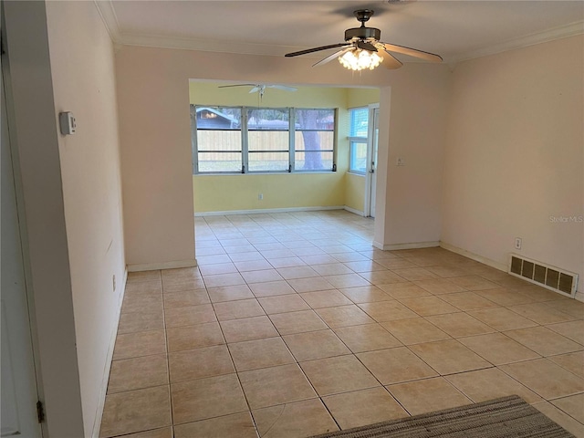 tiled empty room featuring ceiling fan and crown molding