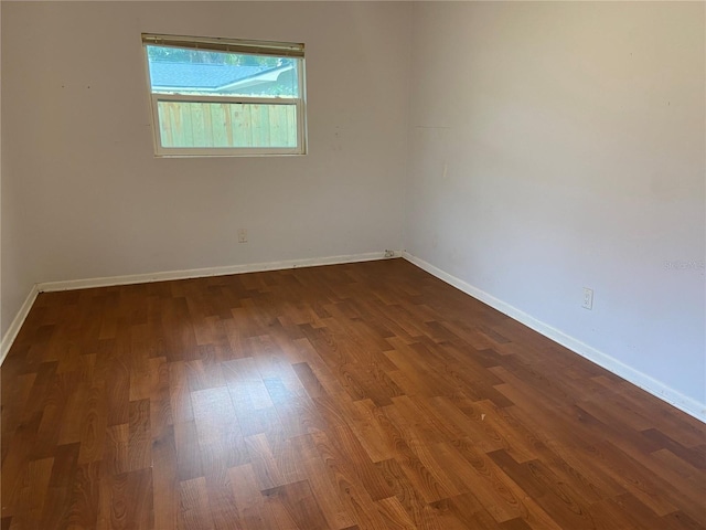 empty room featuring dark hardwood / wood-style flooring