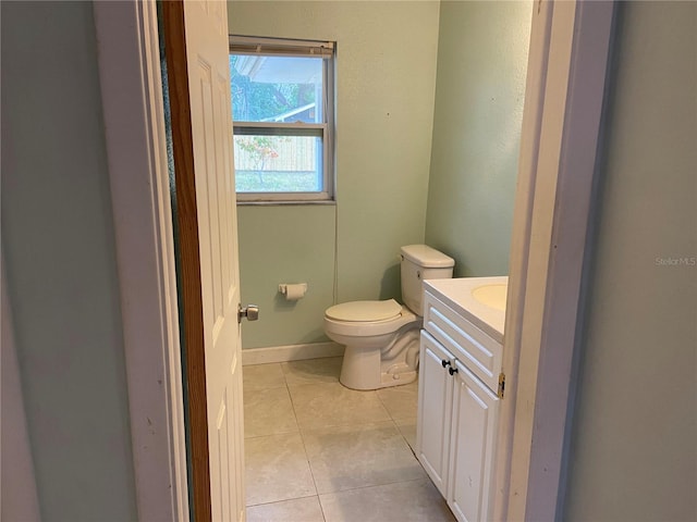 bathroom featuring toilet, tile patterned floors, and vanity