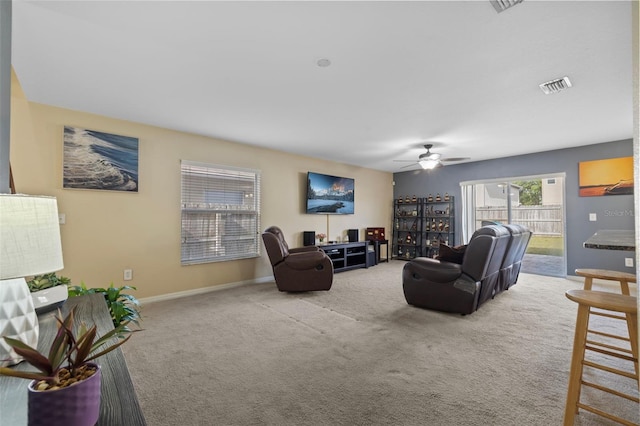 carpeted living room featuring ceiling fan