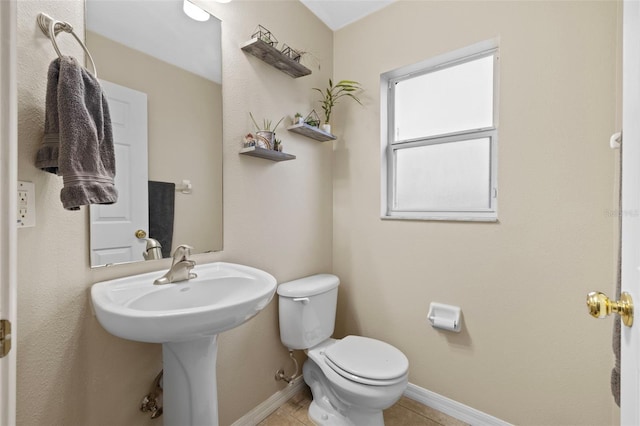 bathroom with toilet and tile patterned floors