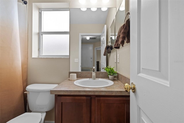 bathroom featuring toilet and vanity