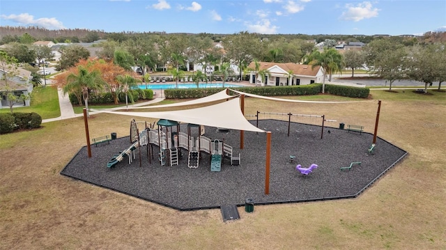 view of play area featuring a lawn and a community pool