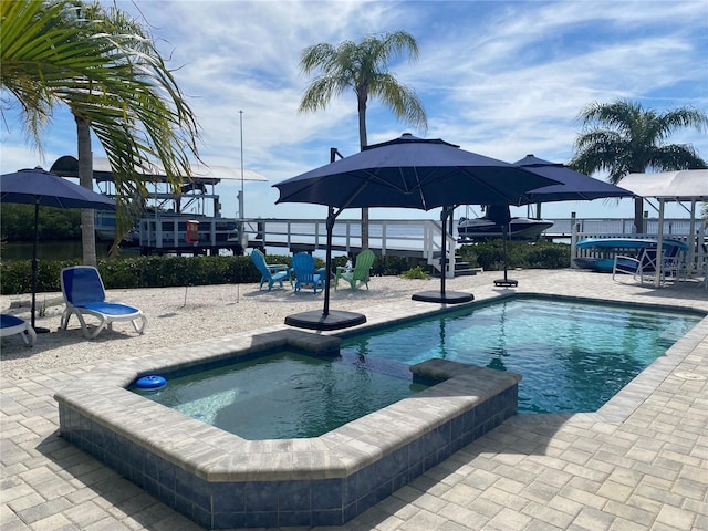 view of swimming pool featuring an in ground hot tub