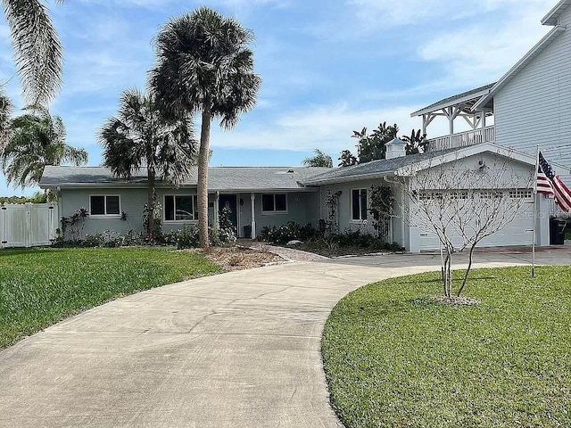 view of front of house featuring a garage and a front lawn