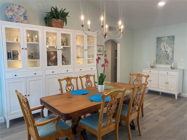 dining room with an inviting chandelier and hardwood / wood-style floors