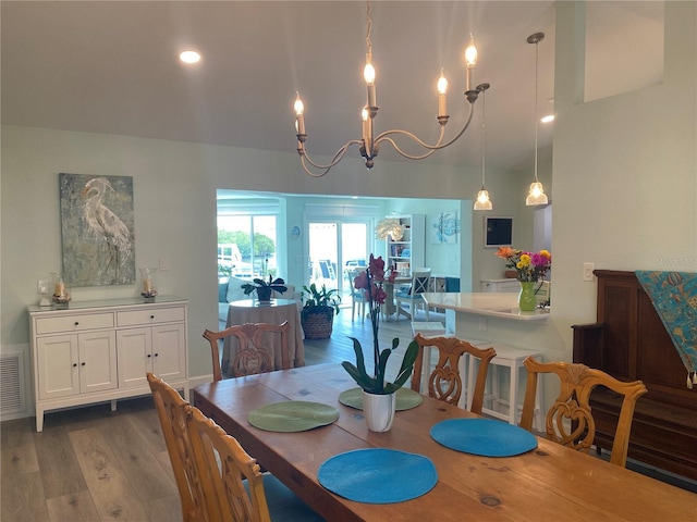 dining area with a notable chandelier and light wood-type flooring