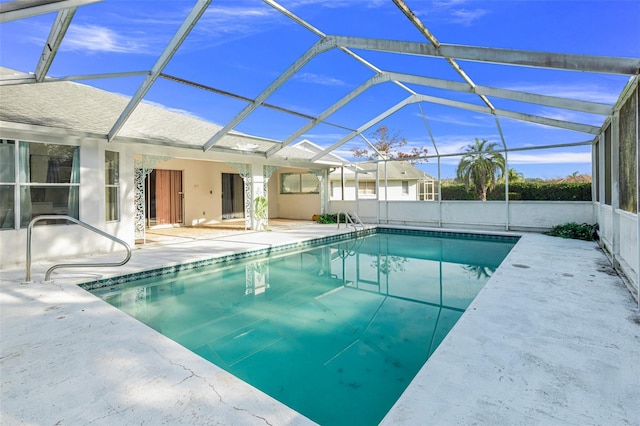 view of swimming pool with a lanai and a patio