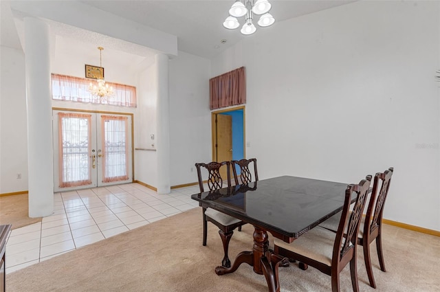 tiled dining space featuring an inviting chandelier and french doors