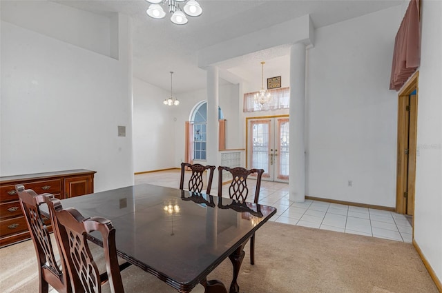 tiled dining area with french doors and a chandelier