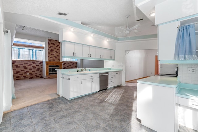 kitchen with vaulted ceiling, white cabinets, ceiling fan, and kitchen peninsula