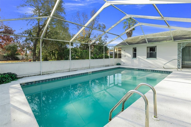 view of swimming pool with a lanai and a patio