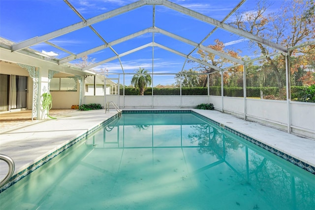 view of pool featuring a patio area and glass enclosure