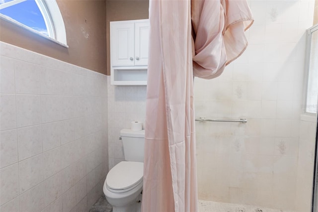 bathroom with walk in shower, tile walls, and toilet