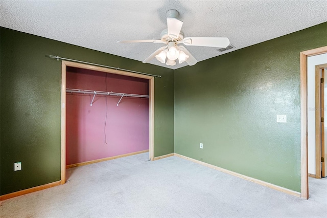 unfurnished bedroom featuring ceiling fan, carpet, a closet, and a textured ceiling