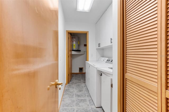 washroom with washer and clothes dryer and cabinets